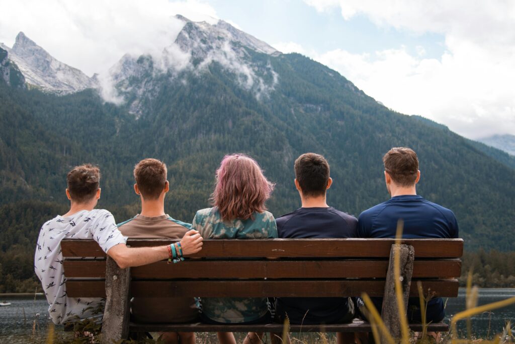 Family seated on a bench enjoying a mountainview