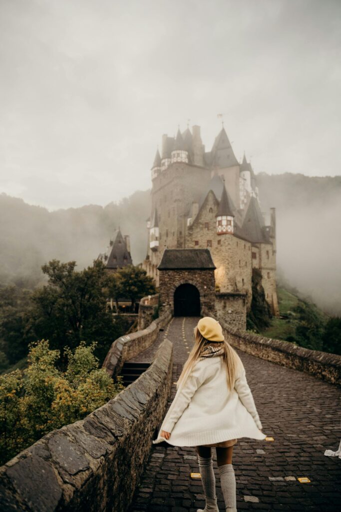 Traveler enjoying a scenic European street during shoulder season, capturing quiet charm and ideal conditions for luxury travel