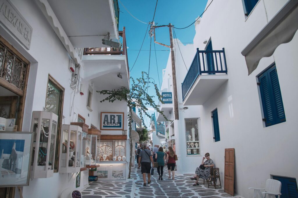 Traveler exploring a charming European street lined with boutiques and cafés, ideal for immersive luxury travel experiences